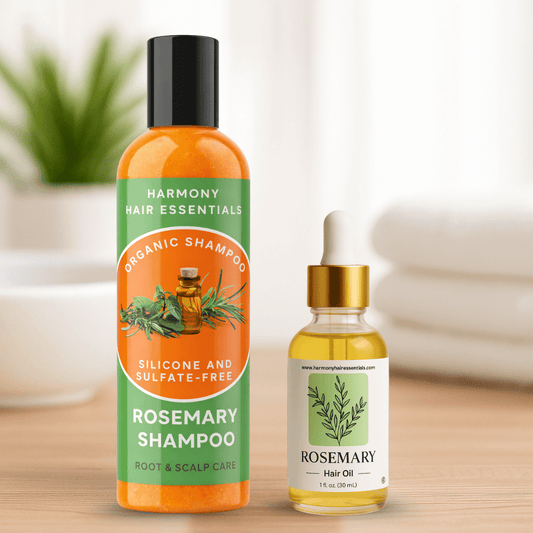 Harmony Hair Essentials rosemary shampoo bottle and hair oil dropper on a wooden surface with a blurred background.